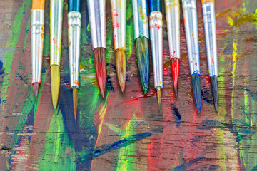 Brushes and watercolors on wooden floors.