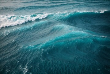 Aerial view of ocean waves. Turquoise water with white foam.