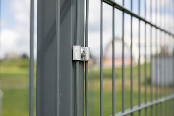Steel panel fence in perspective shot against the sky.