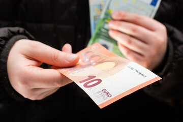 Hands giving cash euro banknotes currencies.