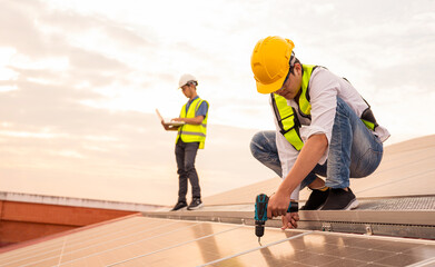 Service Engineer use tablet working inspection installation solar cell on the roof, Technology...