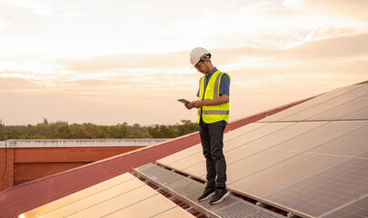 Service Engineer use tablet working inspection installation solar cell on the roof, Technology solar energy renewable.	