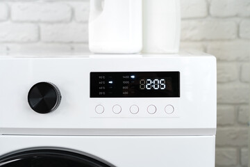 Modern white washing machine in a laundry room