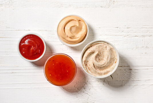 various sauces on white wooden table