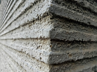 The wall texture is gray with a composition of longitudinal lines