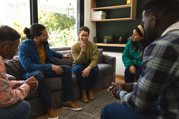 Diverse group of friends talking and supporting each other on therapy session
