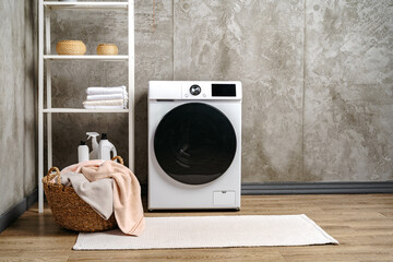 Washing machine in a gray modern laundry room