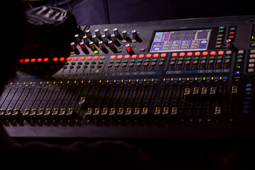a man monitoring Sliders on the audio console.