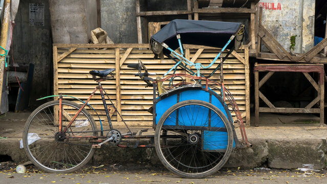 This beca is parked in front of the Ciawitali market, which is at the Guntur terminal in Garut, West Java. The beca owner was taking a break to eat at a rice stall near his beca.
