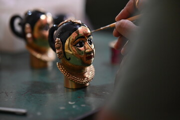 coloring of Goddess face. Red Ink. Hindu Goddess making statue. Face coloring proccess. Brush touch...