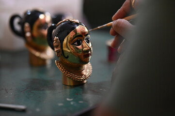 coloring of Goddess face. Hindu Goddess making statue. Face coloring proccess. Brush touch face....