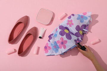 A floral umbrella with shoes, top view.