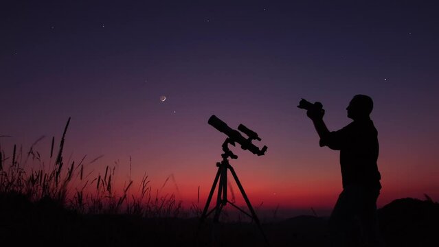 Astronomer with a camera photographing night skies.