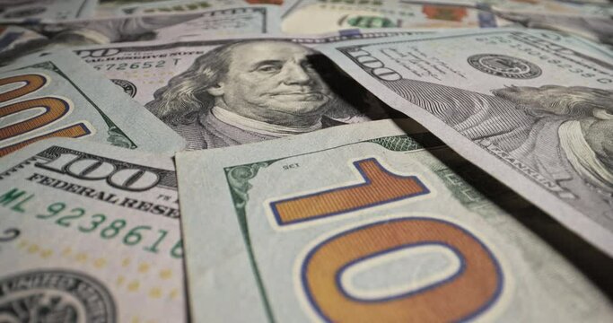Scattered one hundred dollar bills money on table. Close up banknotes American bucks dollars. Power, financial well-being, luxury and material prosperity, limitless possibilities, success concept