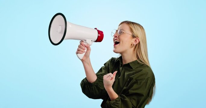 Megaphone, speech and happy woman shouting in studio for info, broadcast or news on blue background. Speaker, noise and excited female model with bullhorn for announcement of sale, deal or promotion
