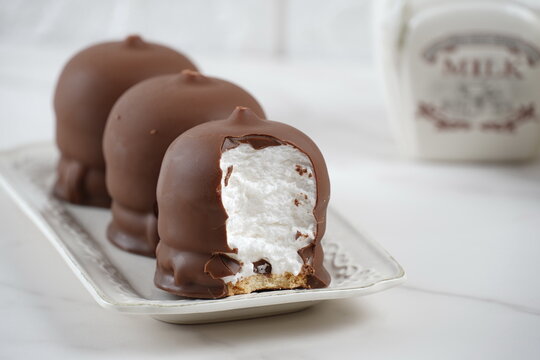 Chocolate-coated marshmallow. Krembo on the table with a cookies. Classic Israeli childhood snack Krembo.