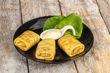 Stuffed pancakes with cream sauce