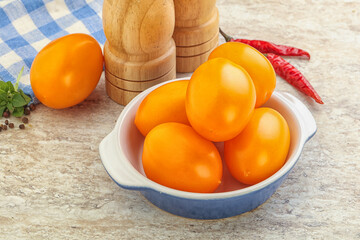 Sweet ripe yellow tomato in the bowl