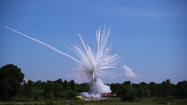 Thai rocket ,sky rocket fireworks is Booming on the blue sky with fire spread for promotion background.