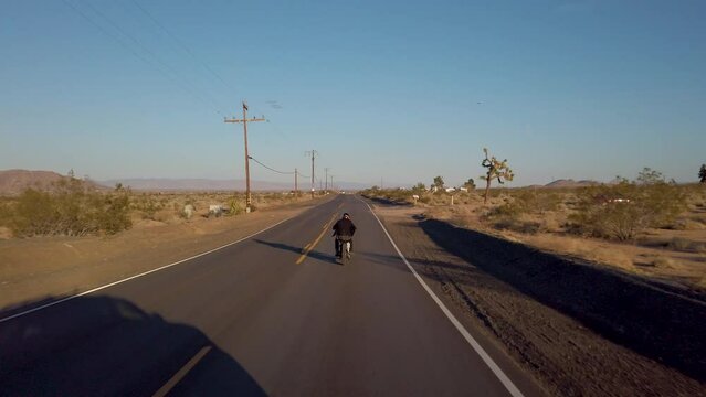 Experience the the open road in this cinematic clip captures as a lone adventurer arrives at an enchanting old farm in the heart of the desert, riding a vintage chopper motorcycle.