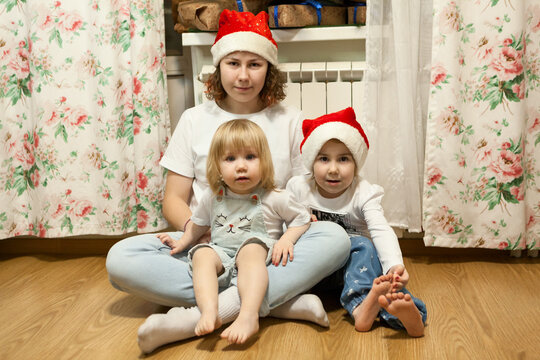 Teenage girl with two little sisters, New Year holiday