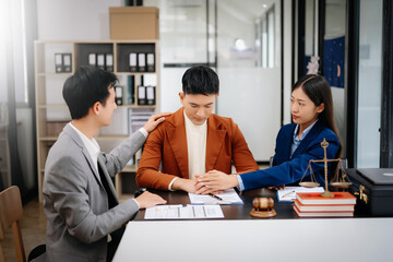 Business people compassionately holding hands and discussing contract papers with laptop and...