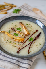 Bowls with tasty creamy soup of parsnip 