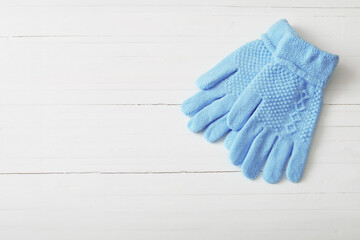 blue gloves on white wooden background