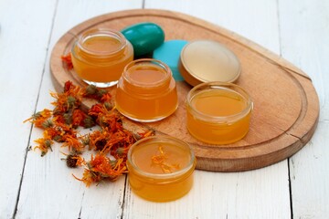 Organic calendula cream for healthy skin. Homemade preparation of organic medicinal ointment from marigold flower heads.  It helps post-surgery to better heal scars.