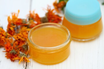 Organic calendula cream for healthy skin. Homemade preparation of organic medicinal ointment from marigold flower heads.  It helps post-surgery to better heal scars.