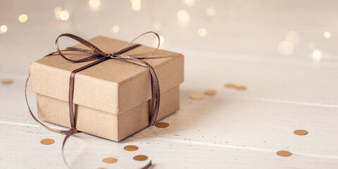 Christmas gift box on white wooden table. Front view. - obrazy, fototapety, plakaty