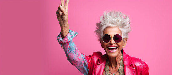 Studio portrait of stylish senior woman showing victory symbol - Happy & funny cool old lady with fashionable clothes portrait on colored background - Youthful grandmother with extravagant - Ai  