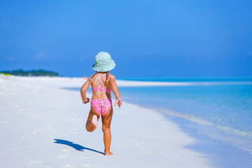 child in bikini on beach in the maldives, model shooting 