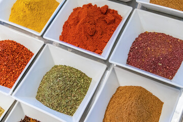 Top view of powdered spices in white porcelain bowls