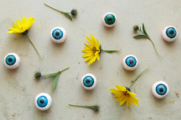 halloween pattern with wild sunflowers and eyeballs on a light background 
