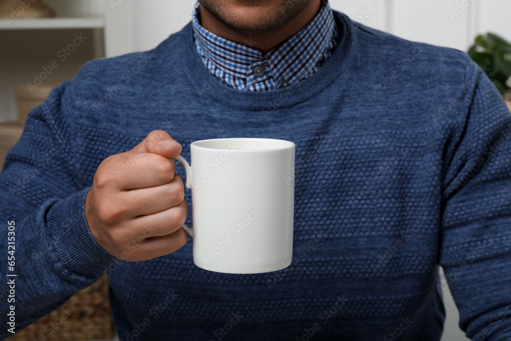 Canvas Prints Man holding white mug indoors, closeup. Mockup for design