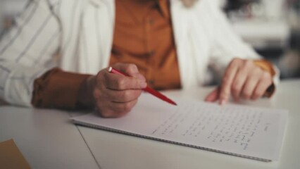 Female teacher checking students essay, grading written assignments, good mark