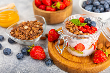 Granola bowl. Yogurt with oatmeal, fresh berries, spirulina and chia seeds. Healthly food. Tasty breakfast. Yogurt with strawberries, raspberries, blueberries, peaches, mint and mendal. Copy space.