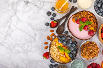 Granola bowl. Yogurt with oatmeal, fresh berries, spirulina and chia seeds. Healthly food. Tasty breakfast. Yogurt with strawberries, raspberries, blueberries, peaches, mint and mendal. Copy space.