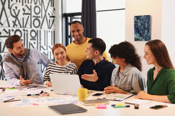 Team of employees working together at table in office. Startup project