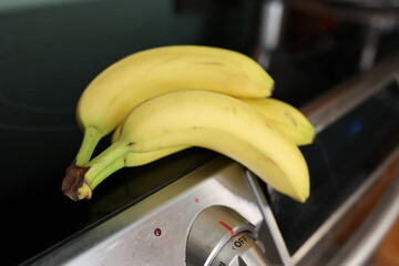 Bunch of bananas placed on the kitchen range cooktop
