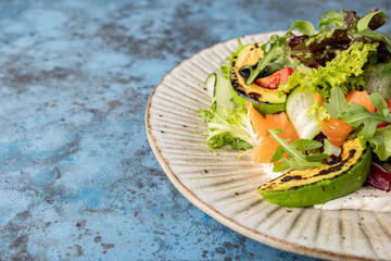 Grilled Salad with Grilled Avocado. Paleo diet. Healthy nutrition. Concept for a tasty and healthy meal. Flatlay.