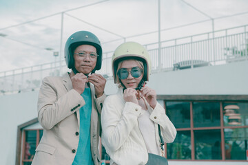 portrait of asian couples wearing safety helmet on city street
