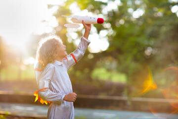 Little boy playing with spaceship. Astronaut kid.