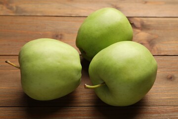 Fresh green apples on wooden table, closeup
