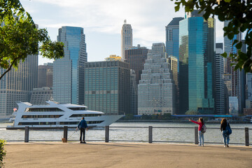 Fototapeta na wymiar Elderly Woman Strolling Through New York with a Stunning Manhattan View