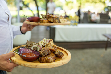 mix meat on a board in a hand for a waiter
