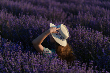 A young woman with a hat in a lavender field