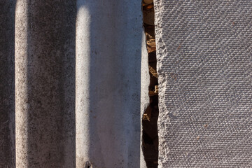The texture of wavy slate, and old flat roofing slate. Close-up