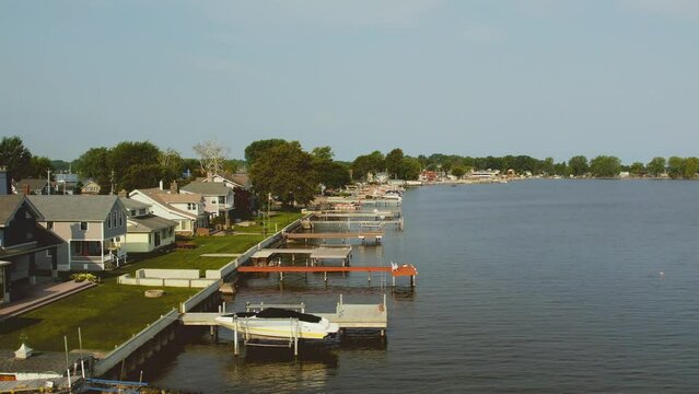 Drone shot floating over the beach houses and boat docks  at Sodus point New York vacation spot at the tip of land on the banks of Lake Ontario.